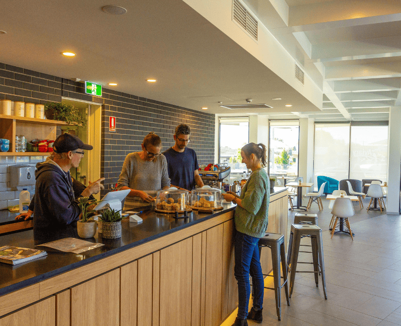 Image shows retail and wholesale staff and customer at a retail cafe