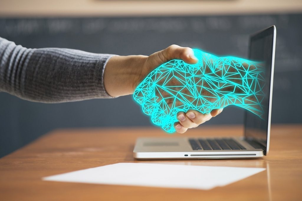 Image shows a huaman hand shaking a digital one 1280 4256272 Image shows a huaman hand shaking a digital one
