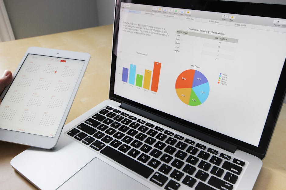 pexels photo 265087 265087 1 Laptop displaying charts and graphs with tablet calendar for data analysis and planning.