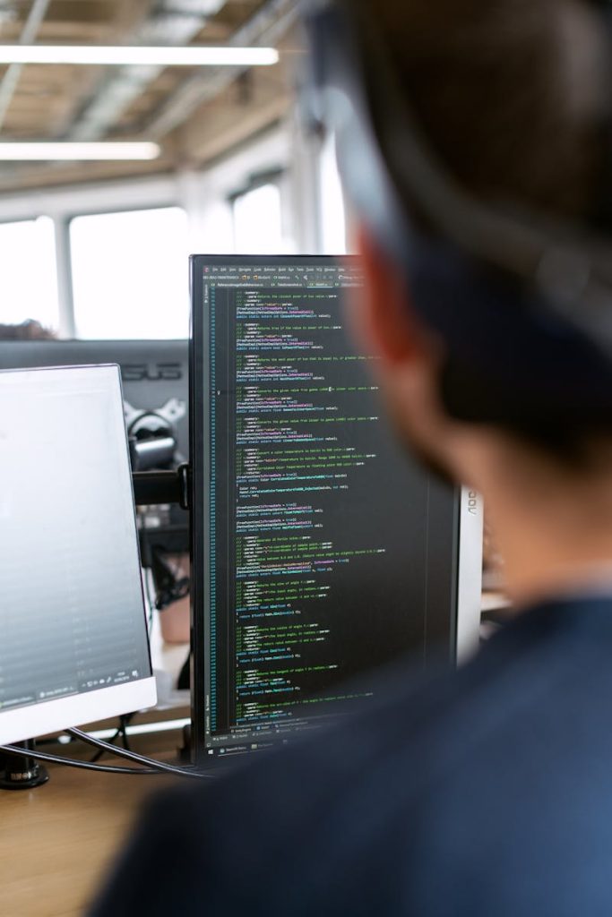 Third party logistics - A male software engineer working on code in a modern office setting.