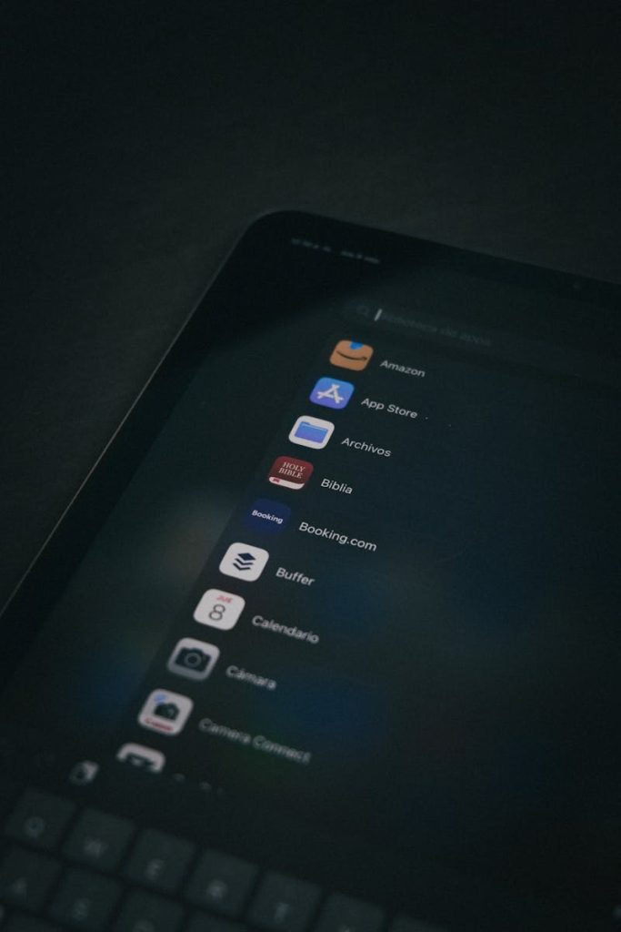 Image shows a dark themed close-up of a tablet screen displaying various applications Image shows a dark themed close-up of a tablet screen displaying various applications